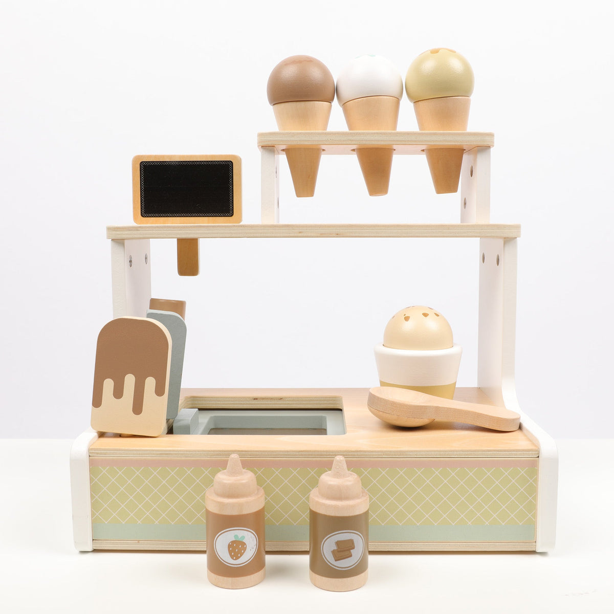 Wooden toy ice cream set with cones, spoons, and bottles on a white background