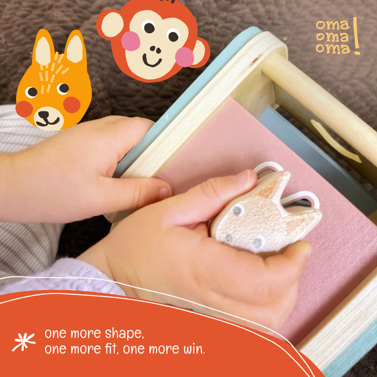 T hand next to the OmaOmaOma wooden shape sorter house showing scale for toddler.