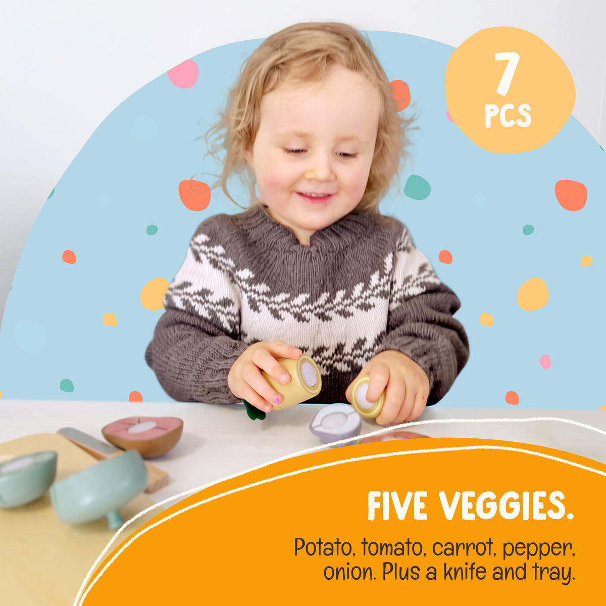 Toddler using the wooden knife to cut a vegetable in the OmaOmaOma cutting set — Montessori practical-life play